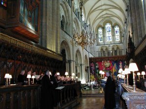 The choir rehearse in the choir stalls at Chichester Cathedral