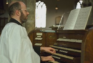 Nigel Day at the console of the organ at St Peter's